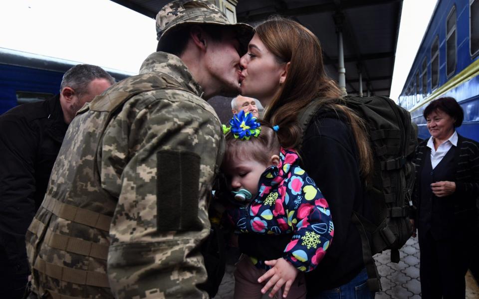 Rodion, a Ukrainian soldier, greets his wife Tetiana and 1-year-old daughter Polina as they arrive at the train station in Kharkiv, Ukraine on May 29, 2022  - Carol Guzy/Zuma Press 