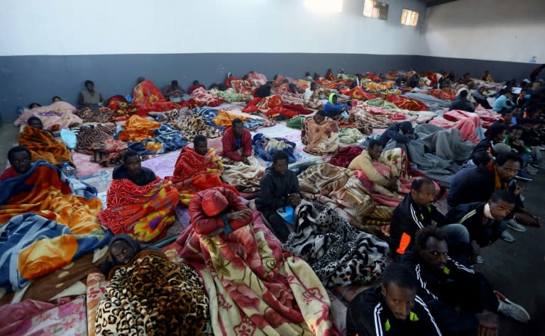 A picture taken on December 11, 2017 shows African migrants sitting in a shelter at the Tariq Al-Matar migrant detention centre on the outskirts of the Libyan capital Tripoli