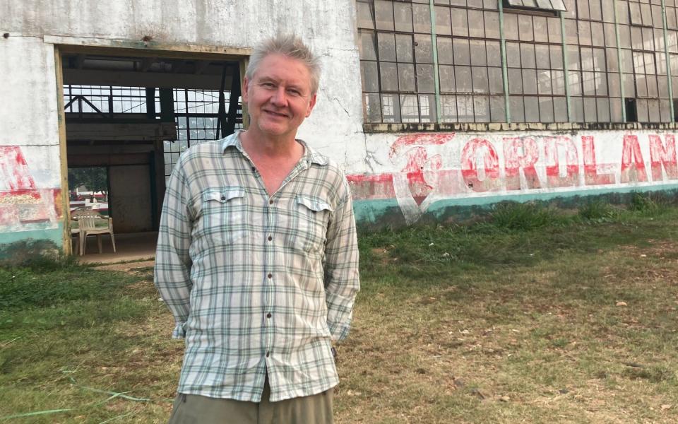 Chris Moss in front of the waterfront warehouse in Fordlândia, Brazil