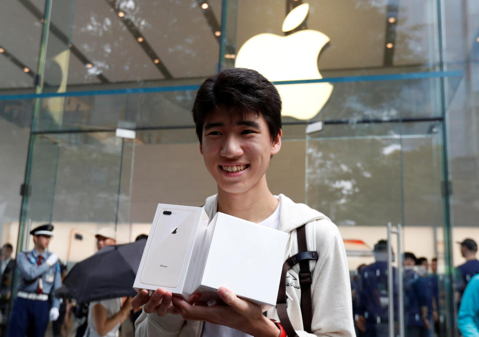 Yokoyama holds Apple’s new iPhone 8 Plus and new Apple Watch after purchasing them at the Apple Store in Tokyo’s Omotesando shopping district