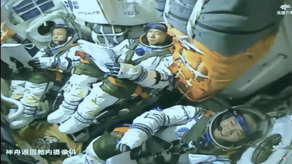 The Shenzhou 15 crew, moments after reaching orbit (left to right): Deng Qingming, vehicle commander Fei Junlong and Zhang Lu. / Credit: CCTV