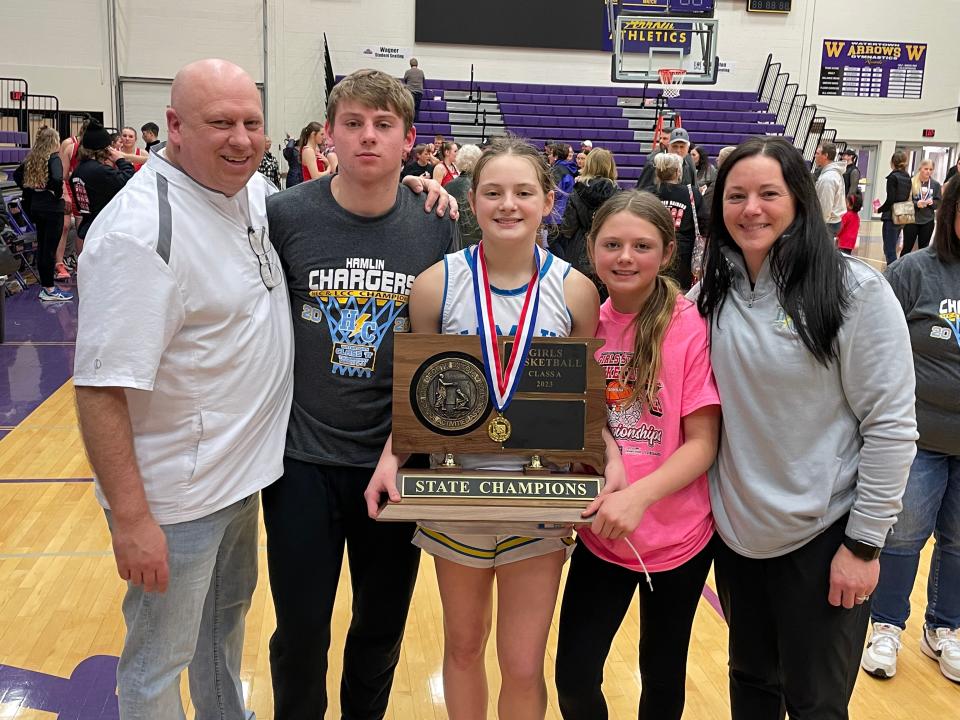 Hamlin basketball coaches Todd (left) and Jaime (right) are pictured with their children Easton, Addison and Paxton after Addison's Hamlin team completed a perfect season by winning the 2023 state Class A girls basketball tournament in the Watertown Civic Arena.