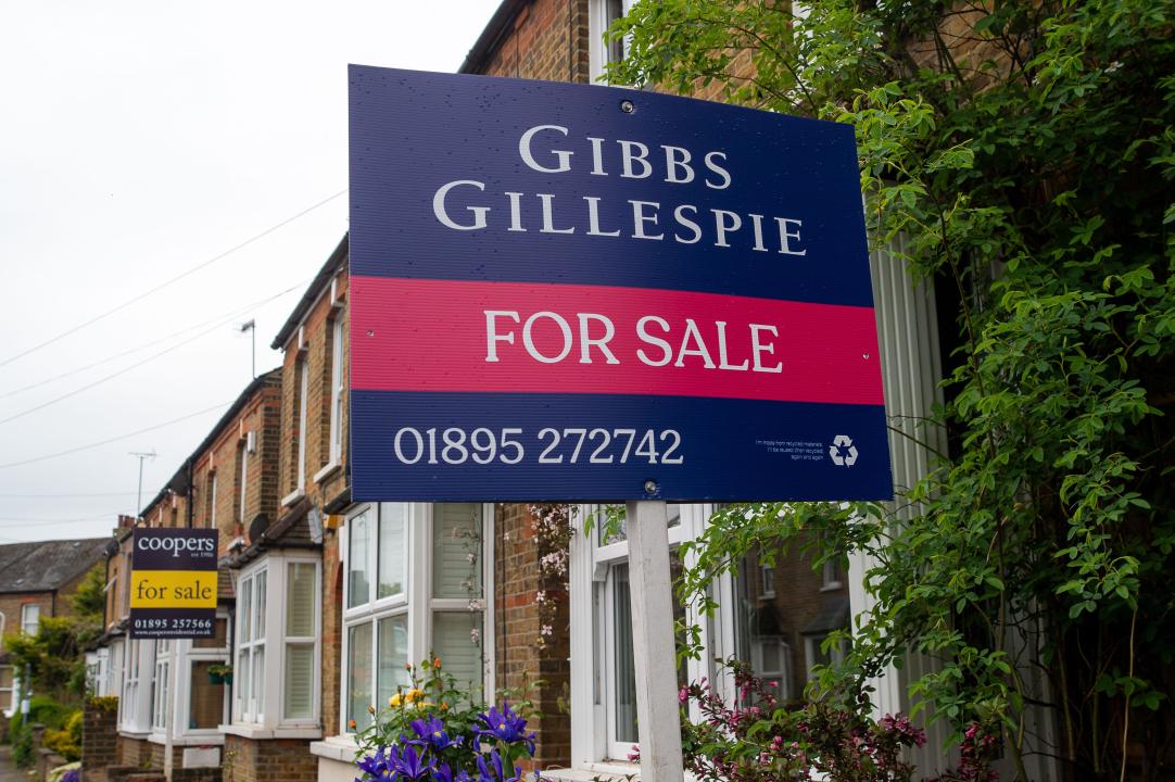 Uxbridge, UK. 27th April, 2024. Estate Agents for sale signs outside terraced houses in Uxbridge in the London Borough of Hillingdon. Credit: Maureen McLean/Alamy