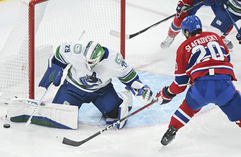 Vancouver Canucks goaltender Casey DeSmith stops Montreal Canadiens' Juraj Slafkovsky during the first period of an NHL hockey game in Montreal, Sunday, Nov. 12, 2023. (Graham Hughes/The Canadian Press via AP)