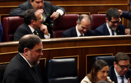 Jailed Catalan politician Oriol Junqueras walks past jailed catalan politicians Jordi Sanchez, Josep Rull and Jordi Turull during the first session of parliament following a general election in Madrid, Spain, May 21, 2019. REUTERS/Sergio Perez/Pool