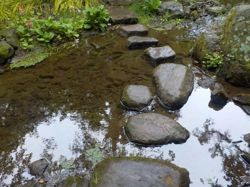 Stones create a path across the water at Chanticleer Garden in Pennsylvania.