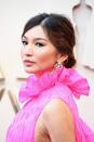 <p>A sharp black cat-eye and wispy bun on Gemma Chan. “I wanted to complement her gorgeous statement gown, so I decided to do a strong graphic liner with emerald green shadow and make Gemma’s eyes the focal point of her makeup," said makeup artist Monika Blunder, who worked with Cle de Peau Beaute.</p>