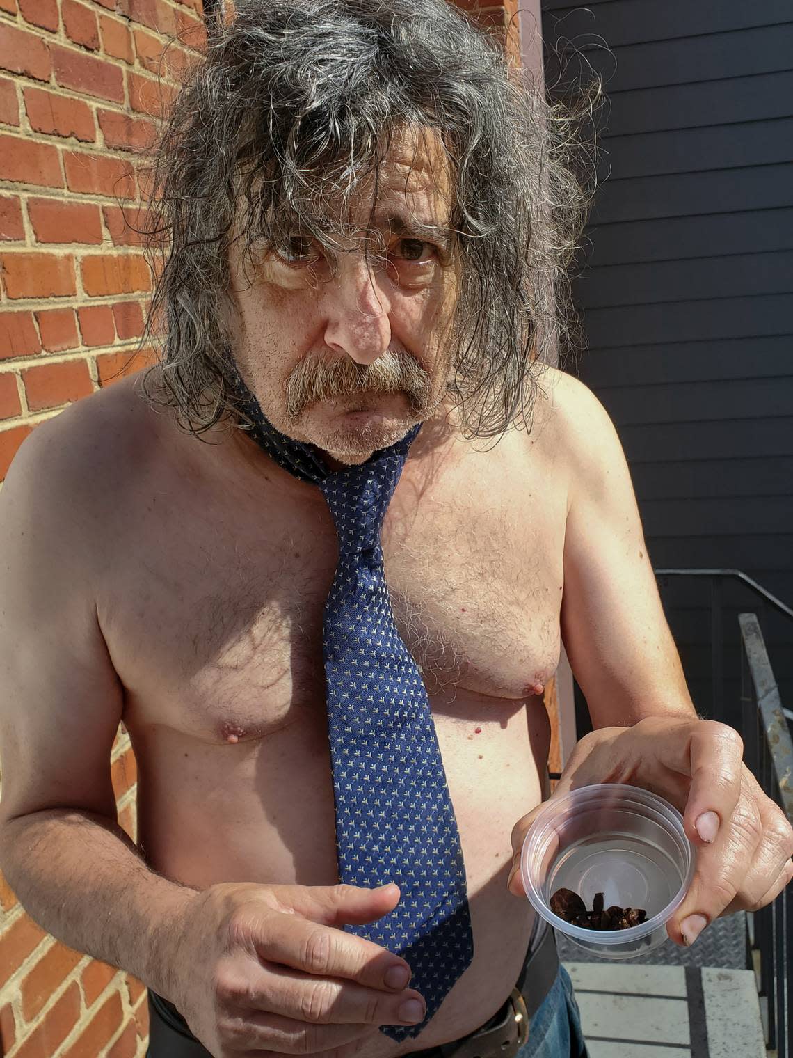 Here is Gene Weingarten snacking on dehydrated tarantula with no shirt and a tie, as one does.