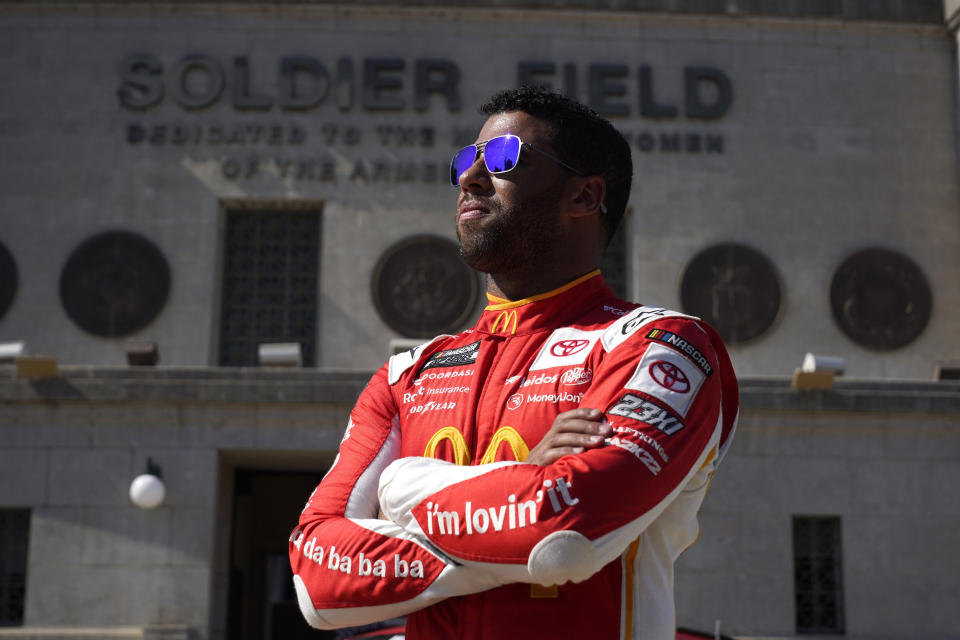 NASCAR driver Bubba Wallace poses for photos outside Soldier Field on Tuesday, July 19, 2022, in Chicago during a promotional visit to announce a Cup Series street race in the city, to be held July 2, 2023. (AP Photo/Charles Rex Arbogast)