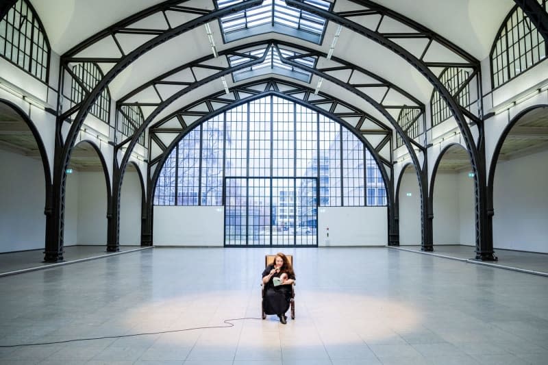 Tania Bruguera, artist and activist, reads from Hannah Arendt's "Elements and Origins of Totalitarianism" before a press event for her performance "Where Your Ideas Become Civic Actions (100 Hours Reading The Origins of Totalitarianism)" at Hamburger Bahnhof - Nationalgalerie der Gegenwart. Christoph Soeder/dpa