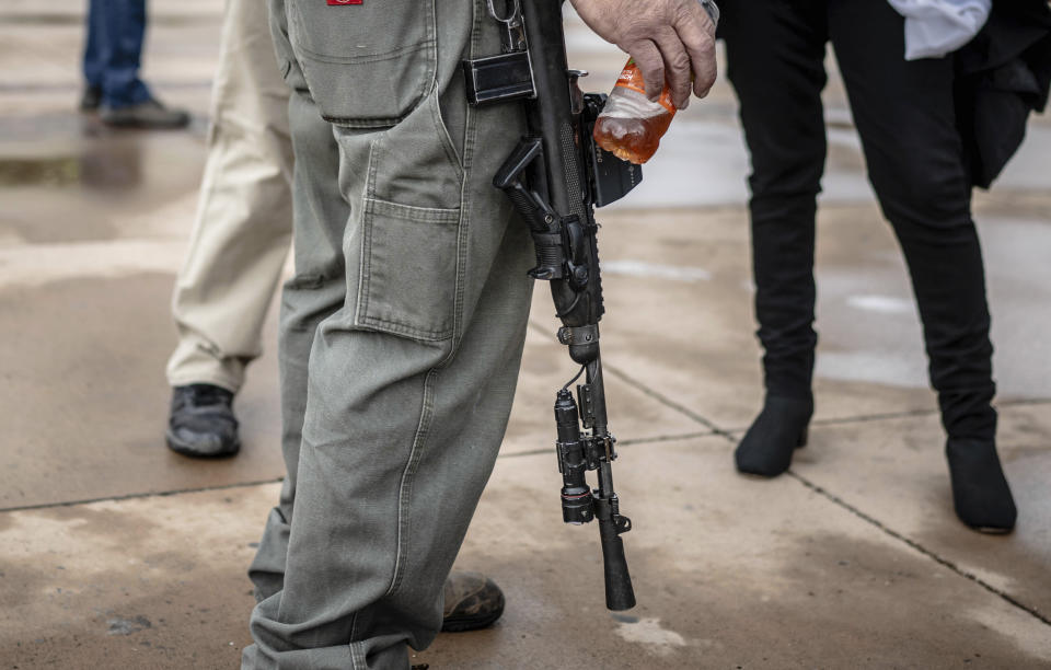 A person carries his assault rifle to a Second Amendment Protest in response to Gov. Michelle Lujan Grisham's recent public health order suspending the conceal and open carry of guns in and around Albuquerque for 30-days, Tuesday, Sept. 12, 2023, in Albuquerque, N.M. (AP Photo/Roberto E. Rosales)