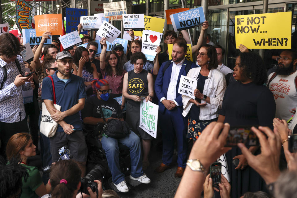 Protesters demonstrate outside New York Gov. Kathy Hochul's Manhattan office, Wednesday, June 5, 2024, in New York. Hochul is indefinitely delaying implementation of a plan to charge motorists big tolls to enter the core of Manhattan, just weeks before the nation's first "congestion pricing" system was set to launch. (AP Photo/Yuki Iwamura)