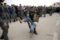 <p>Israeli police remove a pro-settlement activist as they evict settlers from the West Bank settlement of Ofra, Tuesday, Feb. 28, 2017. (AP Photo/Oded Balilty) </p>