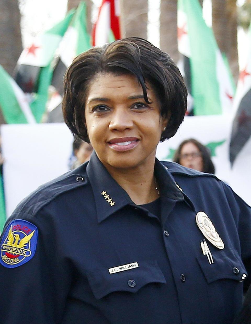 In this Jan. 16, 2017 photo, Phoenix Police Chief Jeri Williams poses for a photograph with other city leaders prior to leading a Martin Luther King Jr. Day march in Phoenix. Williams is among the growing number of women heading departments, many in need of image makeovers. (AP Photo/Ross D. Franklin)