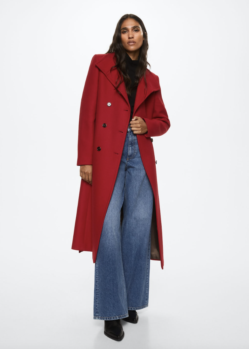 model wearing black top and blue jeans and red Woollen Coat with Belt (Photo via Mango)