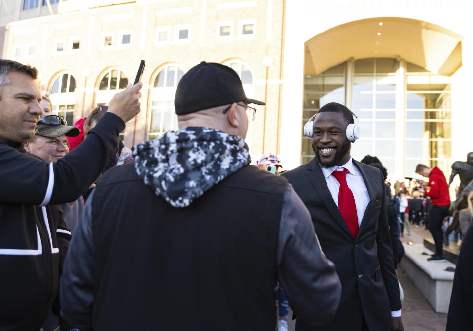 Nebraska safety Marquel Dismuke, right, pauses to greet, fan Charlie Colón, of Lincoln during the team's Unity Walk before playing against Ohio State in an NCAA college football game Saturday, Nov. 6, 2021, at Memorial Stadium in Lincoln, Neb. (AP Photo/Rebecca S. Gratz)