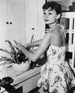 <p>Actress Audrey Hepburn arranges flowers in her New York apartment in 1954. Her film <em>Sabrina</em> would debut later that year.</p>