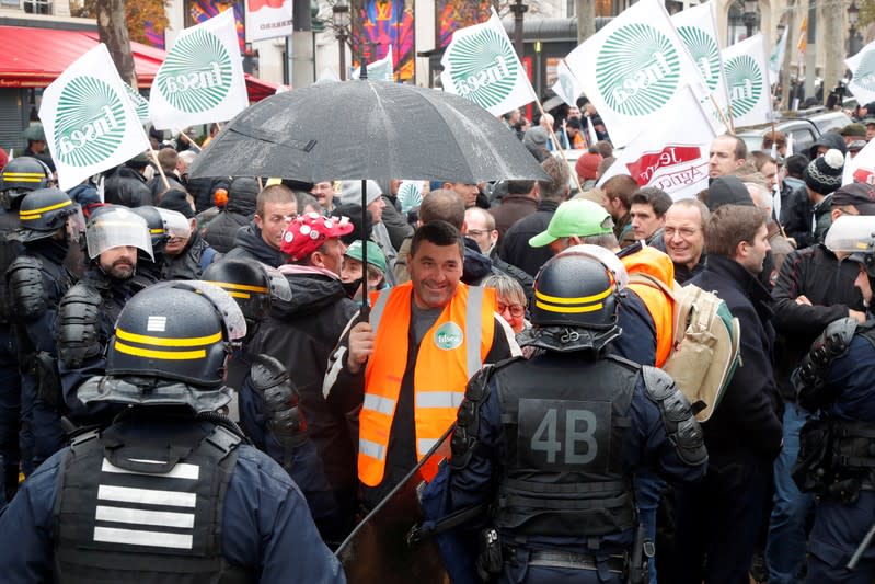 French farmers block the Champs Elysees avenue during a day of protest in Paris