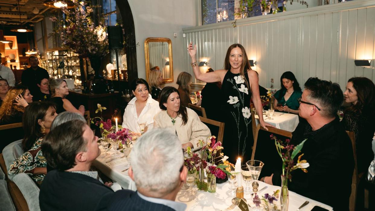 a group of people sitting at a table with candles