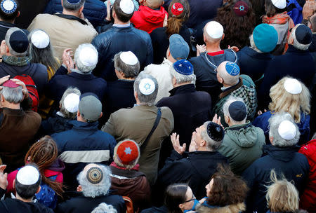 People wear kippas as they attend a demonstration in front of a Jewish synagogue, to denounce an anti-Semitic attack on a young man wearing a kippa in the capital earlier this month, in Berlin, Germany, April 25, 2018. REUTERS/Fabrizio Bensch