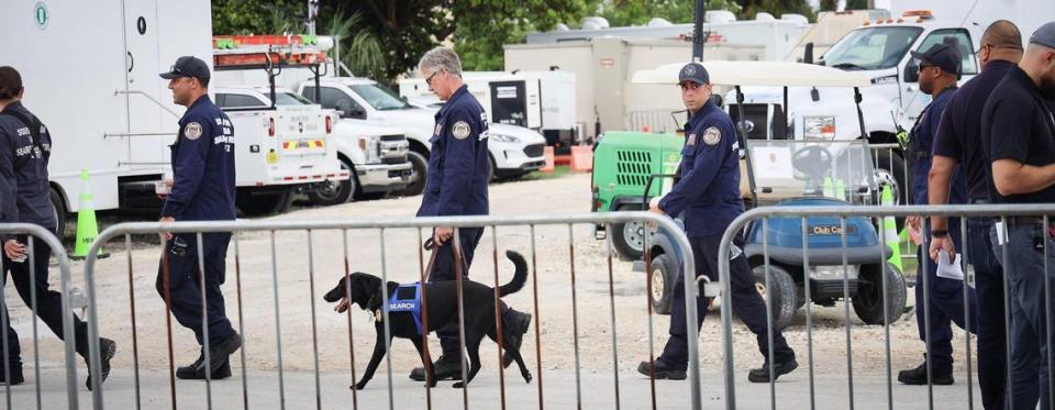 Members of the South Florida Urban Search and Rescue (FL-TF2) walk between the Miami-Dade County operation and media centers during the morning press conference. Miami-Dade and Surfside mayors updated the media on the overnight and daily operational details while announcing 90 people who have been confirmed dead due to the partial collapse of the Champlain Towers South in Surfside, Florida on Sunday, July 11, 2021.