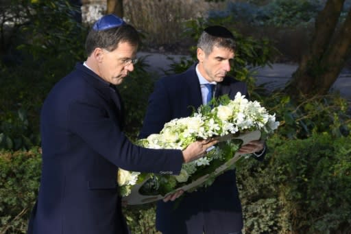 Prime Minister Marke Rutte (l) laid a wreath at the Auschwitw Never Again monument during the ceremony in Amsterdam