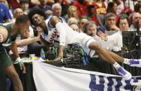 <p>Kansas guard Josh Jackson (11) crashes into the scorers’ table with Michigan State guard Joshua Langford, left, in the second half of a second-round game in the men’s NCAA college basketball tournament in Tulsa, Okla., Sunday, March 19, 2017. (AP Photo/Sue Ogrocki) </p>