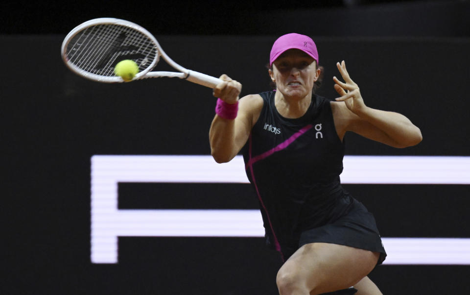 Poland's Iga Swiatek plays a return to Belgium's Elise Mertens during the women's singles round of 16 tennis match at the WTA Tour in Stuttgart, Germany, Thursday April 18, 2024. (Marijan Murat/dpa via AP)