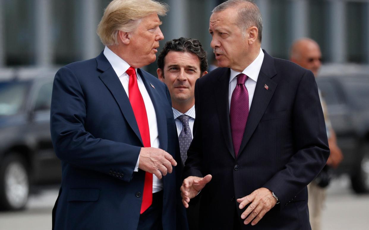 President Donald Trump, left, talks with Turkey's President Recep Tayyip Erdogan, as they arrive together for a summit of heads of state and government at NATO headquarters in Brussels - AP