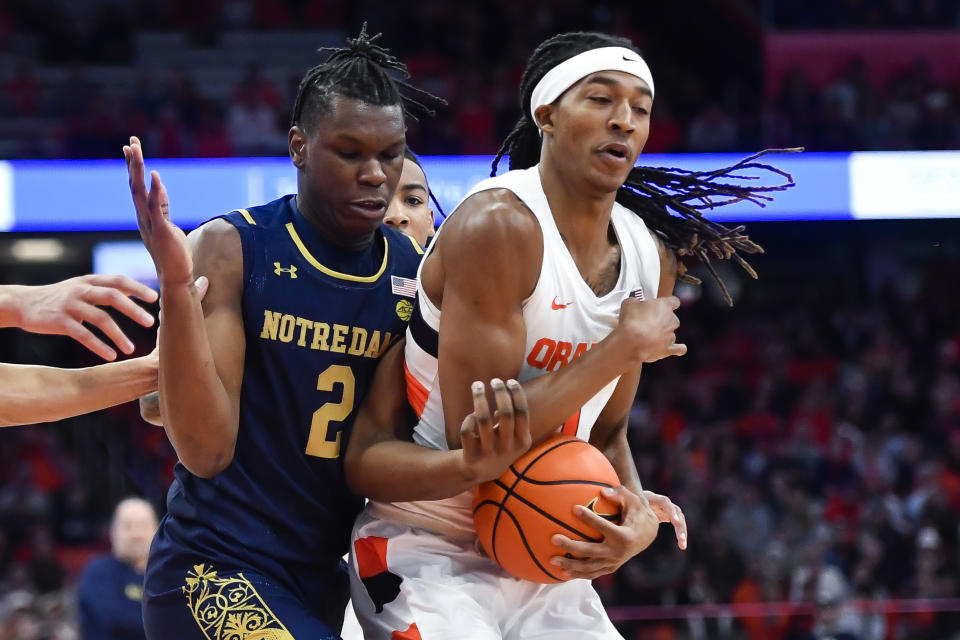 Syracuse forward Maliq Brown, right, steals the ball from Notre Dame forward Ven-Allen Lubin during the first half of an NCAA college basketball game in Syracuse, N.Y., Saturday, Jan. 14, 2023. (AP Photo/Adrian Kraus)