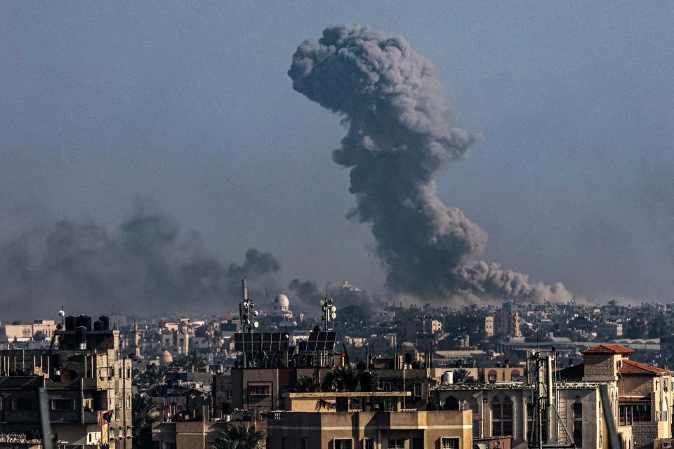 A picture taken from Rafah shows smoke billowing over Khan Yunis in the southern Gaza Strip during Israeli bombardment on Dec. 30, 2023, as battles between the Palestinian Hamas movement and Israel continue.