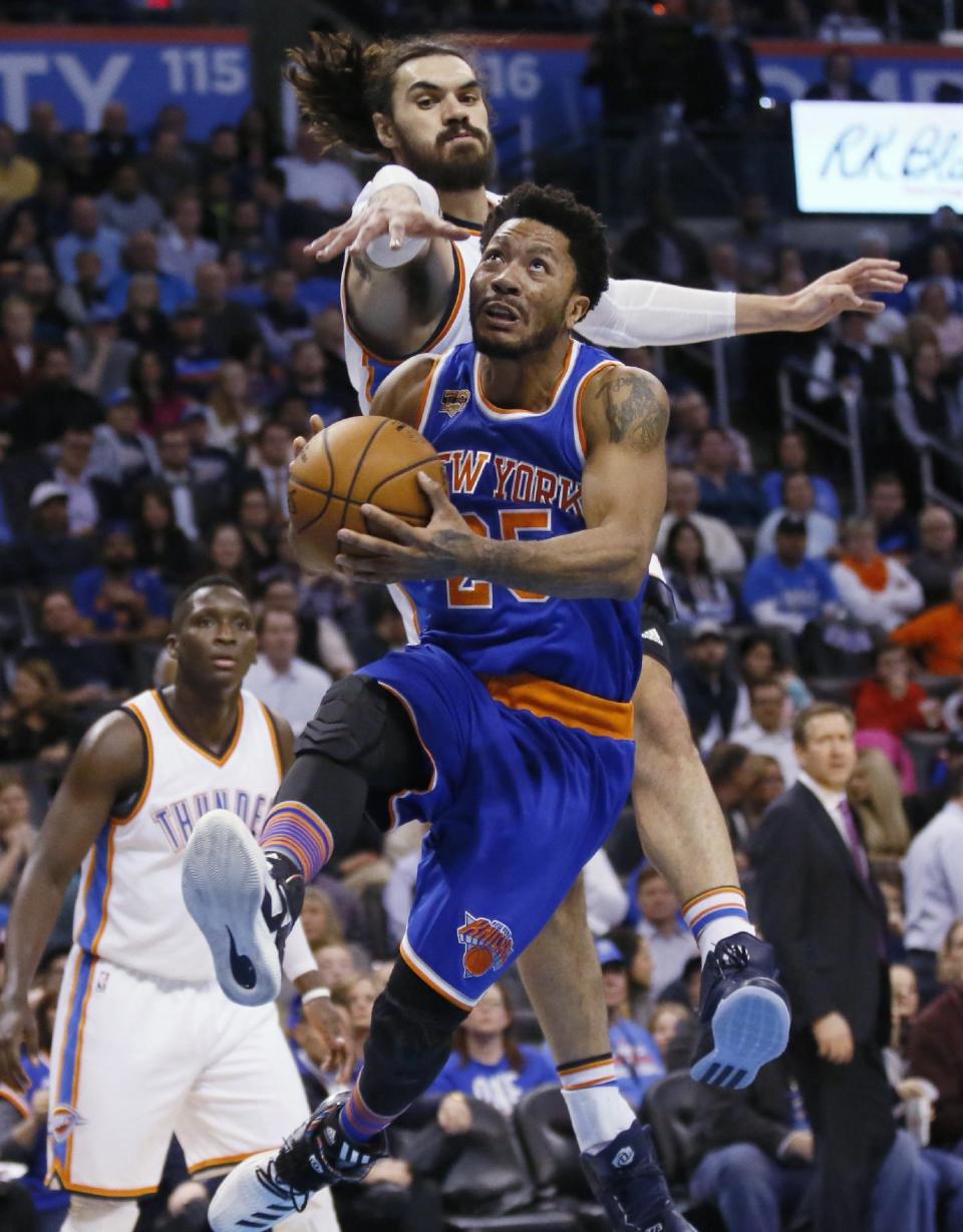New York Knicks guard Derrick Rose drives to the basket in front of Oklahoma City Thunder center Steven Adams, top, during the second quarter of an NBA basketball game in Oklahoma City, Wednesday, Feb. 15, 2017. (AP Photo/Sue Ogrocki)