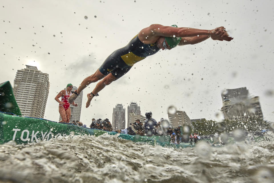 <p>Jaz Hedgeland of Team Australia dives into the water during the Women's Individual Triathlon on day four of the Tokyo 2020 Olympic Games at Odaiba Marine Park on July 27, 2021 in Tokyo, Japan. (Photo by Adam Pretty/Getty Images)</p> 