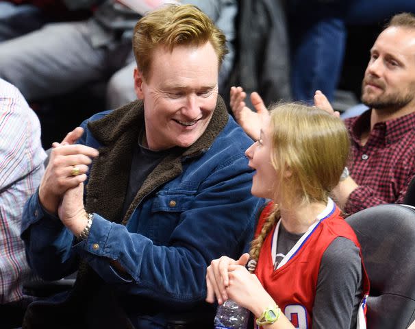 <p>Noel Vasquez/GC Images</p> Conan O'Brien and his daughter Neve O'Brien attend a basketball game between the Houston Rockets and the Los Angeles Clippers on January 18, 2016 in Los Angeles, California.