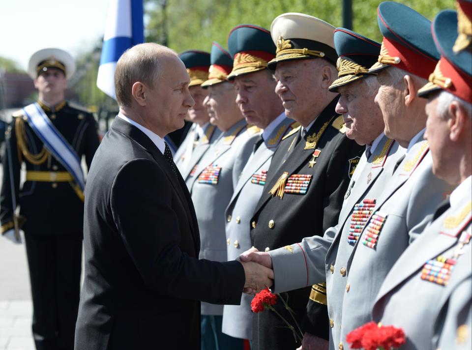 Russian President Vladimir Putin shakes hands with senior officers at a wreath laying ceremony at the Tomb of Unknown Soldier at the Kremlin wall on the eve of Victory Day marking the defeat of Nazi Germany 69 years ago in Moscow, Russia, on Thursday, May 8, 2014. Russia will mark Victory Day on May 9 holding a military parade in Red Square in Moscow. (AP Photo/RIA-Novosti, Alexei Nikolsky, Presidential Press Service)