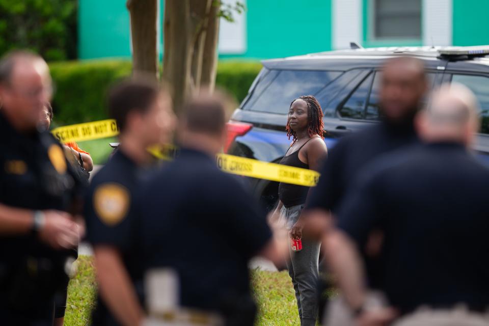 People gather at the edge of crime scene tape as the Tallahassee Police Department investigates a shooting that occurred at Griffin Heights Apartments early Monday morning, June 17, 2024. One woman was killed and another is in serious condition.