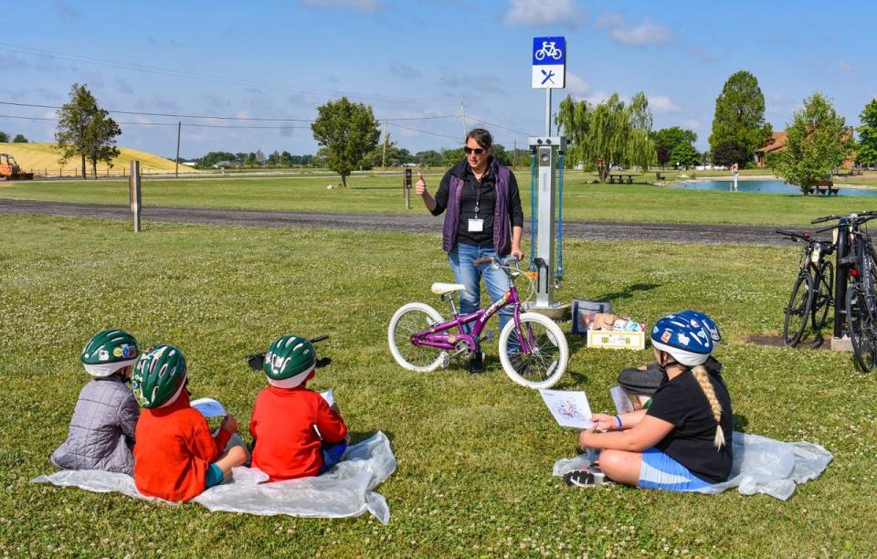Jannah Wilson, the executive director of the Park District of Ottawa County, teaches basic bike maintenance to participants of Bike Safety Day on June 14.