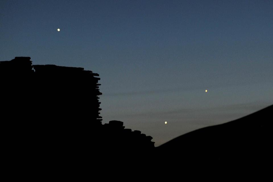 <p>Stan Honda/Getty Images</p> The planets Jupiter (L), Venus (C) and Mercury (R) are seen in an unusual conjunction setting over the Wupatki pueblo ruin on May 24, 2013 at Wupatki National Monument north of Flagstaff, Arizona.