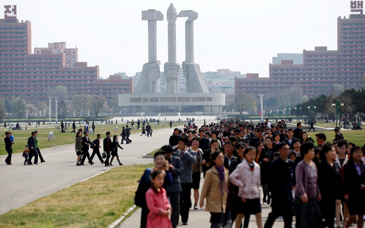 People walk in front of the Monument to the Foundation of the Workers' Party in Pyongyang, North Korea - Reuters