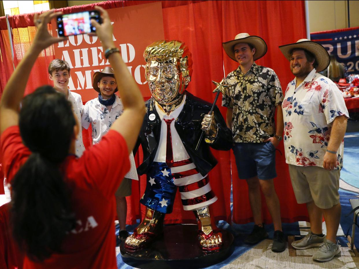 People take a picture with former President Donald Trump’s statue on display at CPAC on February 27, 2021 in Orlando, Florida.  (Getty Images)