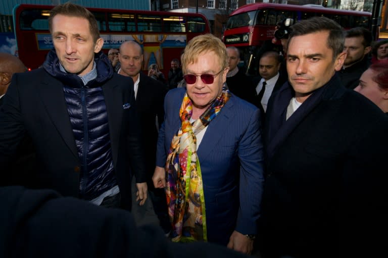 British singer Elton John (C) arrives at a HMV store in central London on February 3, 2016 for an event to promote the release of his new album "Wonderful Crazy Night"