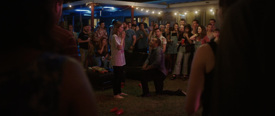 All eyes are on a young couple (Johanna Braddy and Jacob Artist) at a raucous Austin shindig in "The Get Together."