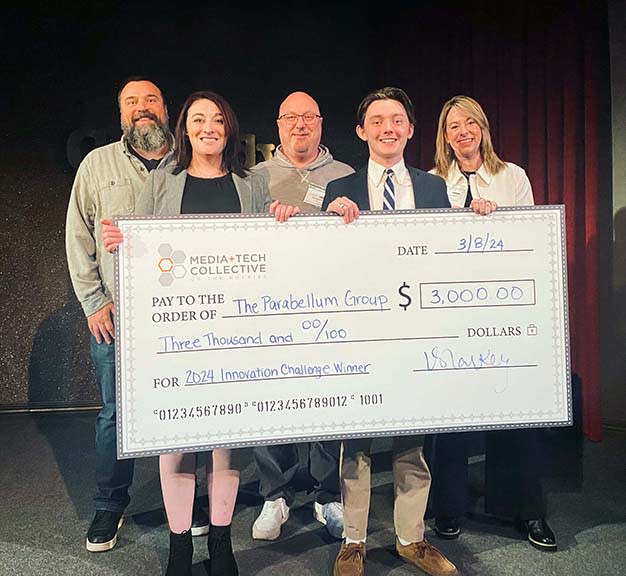 Team “Parabellum Group” from the University of Denver celebrate their win at the 17th annual Media+Tech Collective of the Rockies Innovation Challenge competition. (From l.): judge Mark Bridges of CableLabs, winner Lis McLaughlin, judge David Sedlock of Zayo, winner Benjamin Shorb and judge Brooke Puter of Comcast.