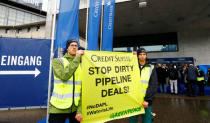 Activists of environmental group Greenpeace display a poster to protest against the financing of the Dakota-Access oil pipeline ahead of Swiss bank Credit Suisse's annual shareholder meeting in Zurich, Switzerland April 28, 2017. REUTERS/Arnd Wiegmann