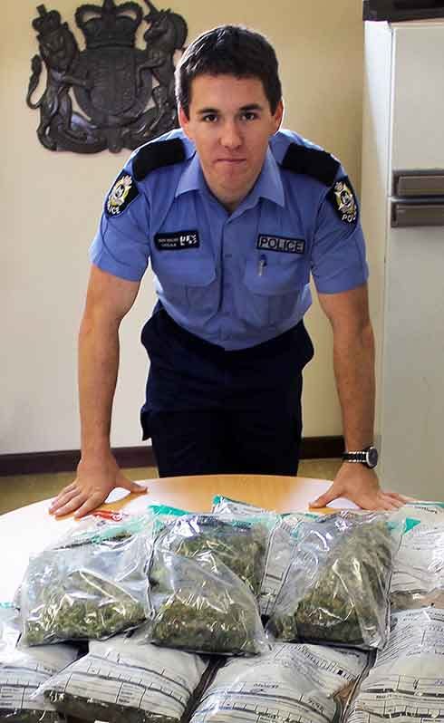 Pemberton police Const. Brad Walder displays more than 5kg of cannabis seized from properties in Northcliffe and Pemberton, which has left two men facing multiple drug charges.