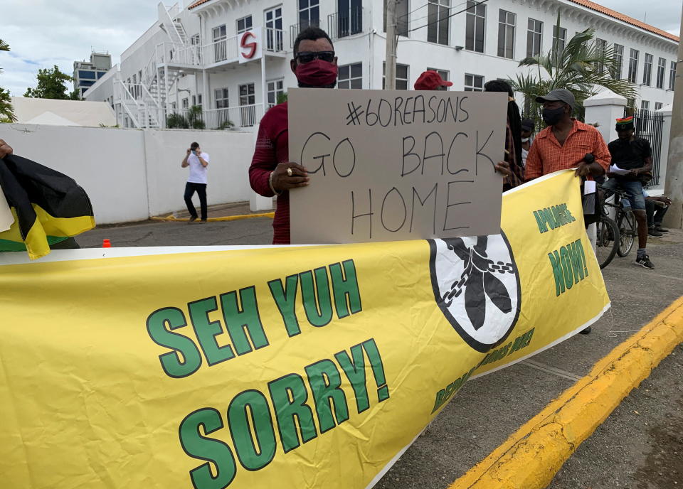 Protesters gather outside an office of the British government to demand that the United Kingdom pay reparations for centuries of slavery, in advance of a visit by Prince William and Catherine, the Duke and Duchess of Cambridge, in Kingston, Jamaica March 22, 2022. / Credit: STRINGER/REUTERS