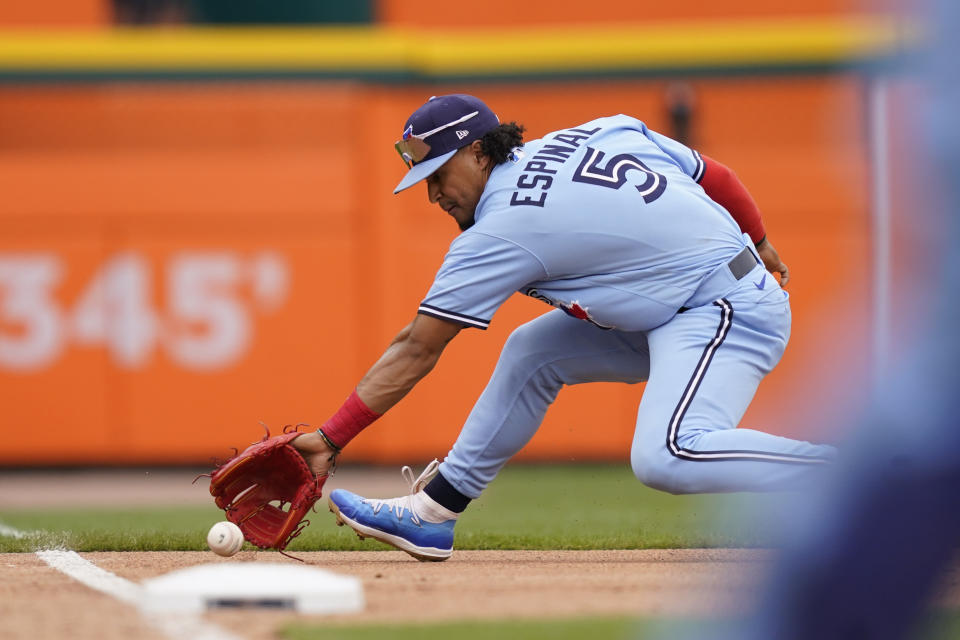 Toronto Blue Jays third baseman Santiago Espinal fields the grounder hit by Detroit Tigers' Spencer Torkelson and throws him out at first during the fourth inning of a baseball game, Saturday, June 11, 2022, in Detroit. (AP Photo/Carlos Osorio)