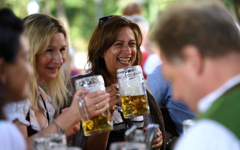 People attend the tapping of the first barrel at a beer garden in Munich - REUTERS/Andreas Gebert