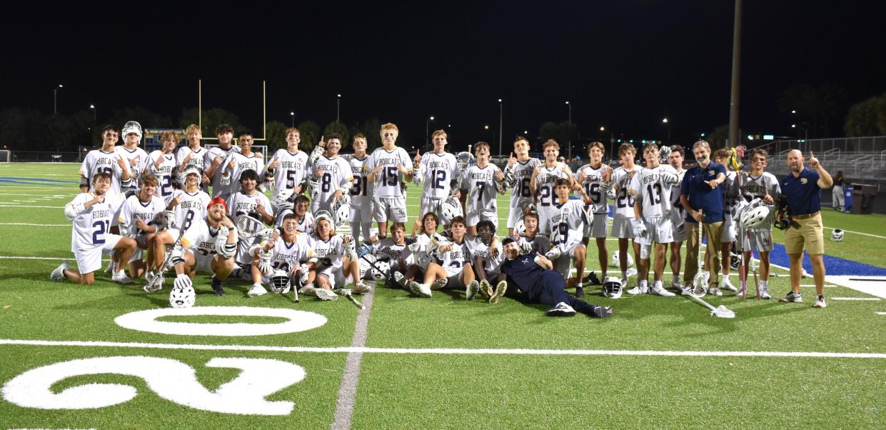 The Boca Raton boys lacrosse team poses for a celebratory photo after defeating Martin County in their regional quarterfinals matchup on April 25, 2024.
