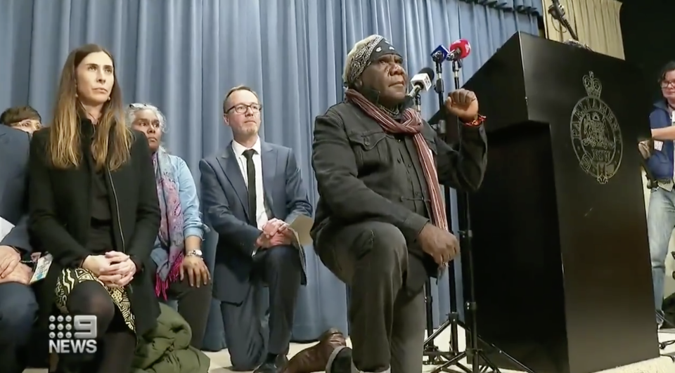 The Indigenous boy's family took a knee on stage during a press conference in Sydney.